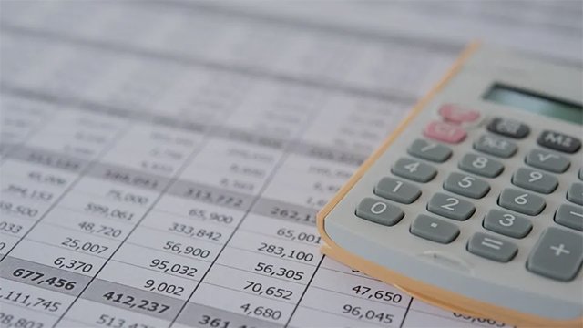 Calculator on a printed accounting spreadsheet.